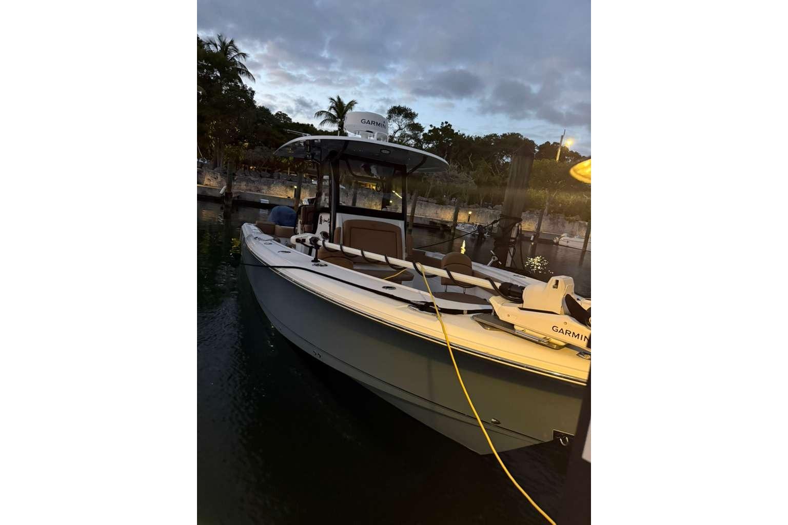 2021 Sea Hunt Gamefish 30 boat docked at sunset with Garmin equipment.