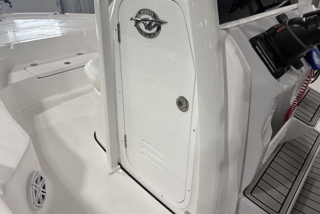 2026 Tidewater 2210 Carolina Bay boat interior with sleek white design and storage compartment.
