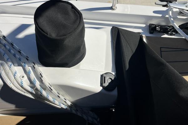 Deck of 2025 Hanse 360 sailboat with ropes and protective covers.
