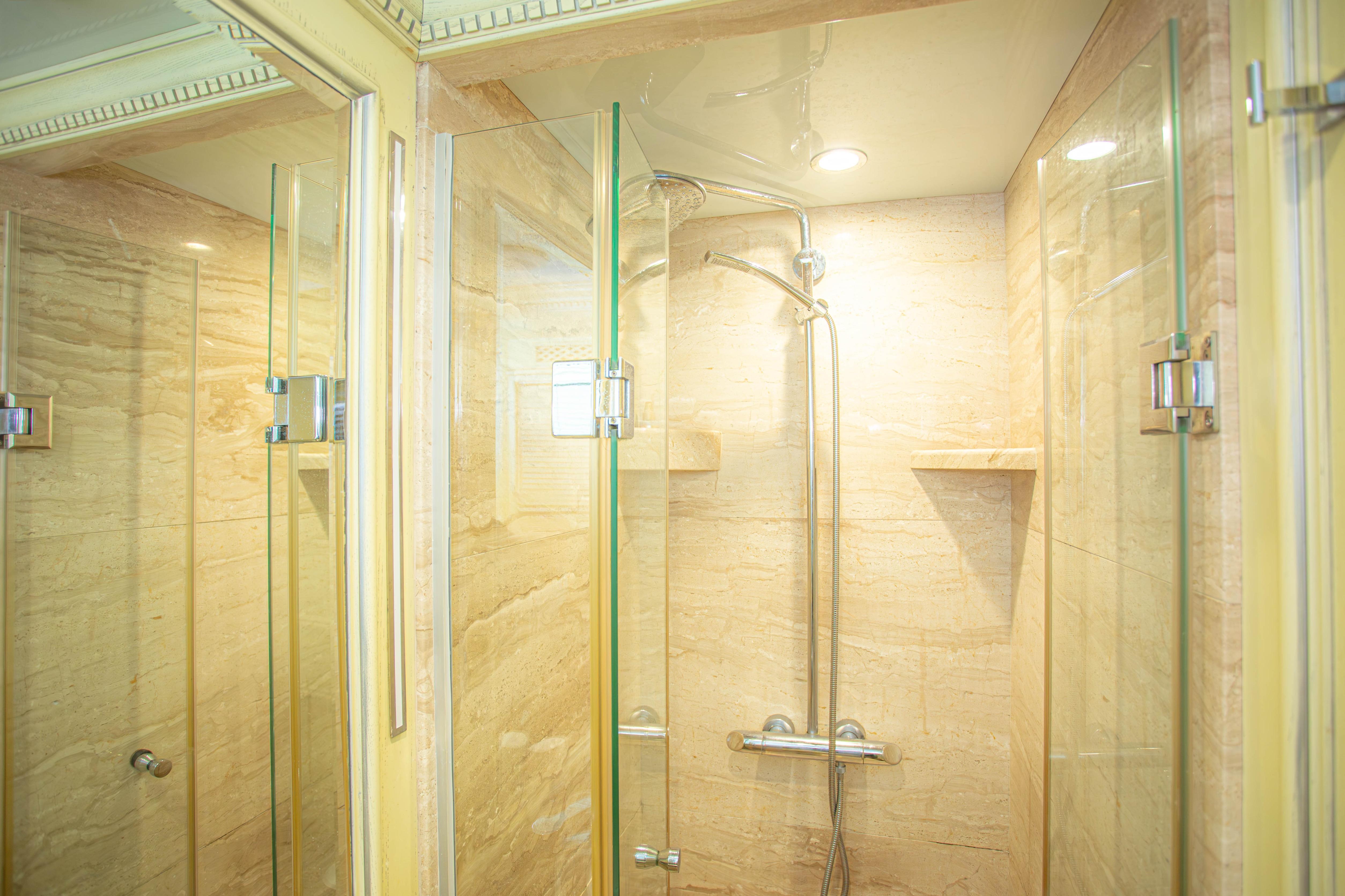 Luxurious marble shower in 2014 Fifth Ocean Yachts 24m Explorer Yacht bathroom.
