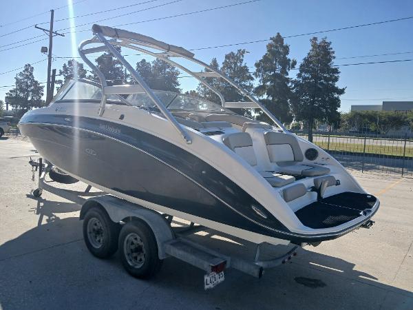 2010 Yamaha Boats 242 Limited on trailer, sleek design, outdoor setting.