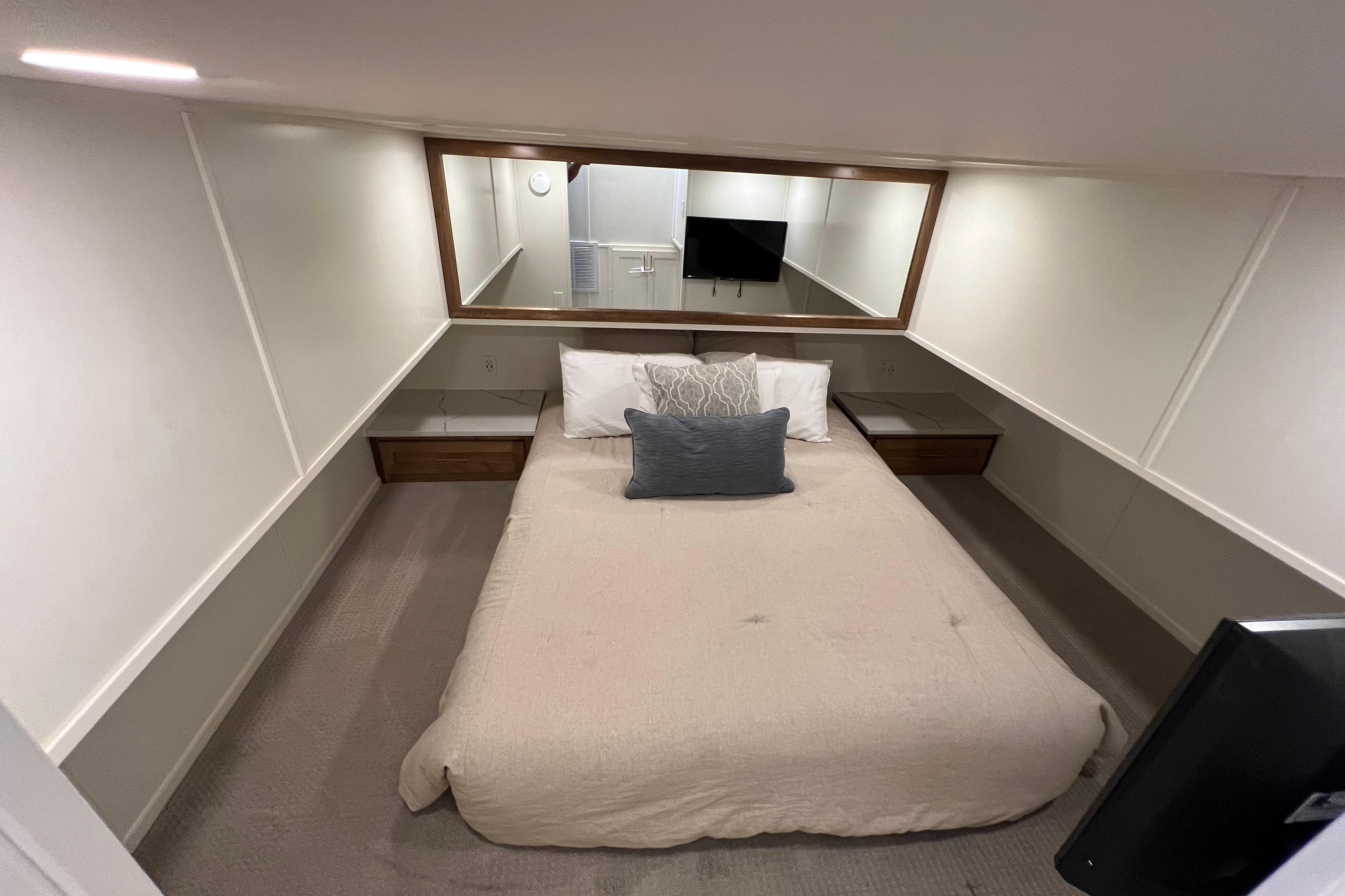 Cozy bedroom in 2025 Sumerset Excellence Multiple Shares houseboat, featuring modern decor and TV.