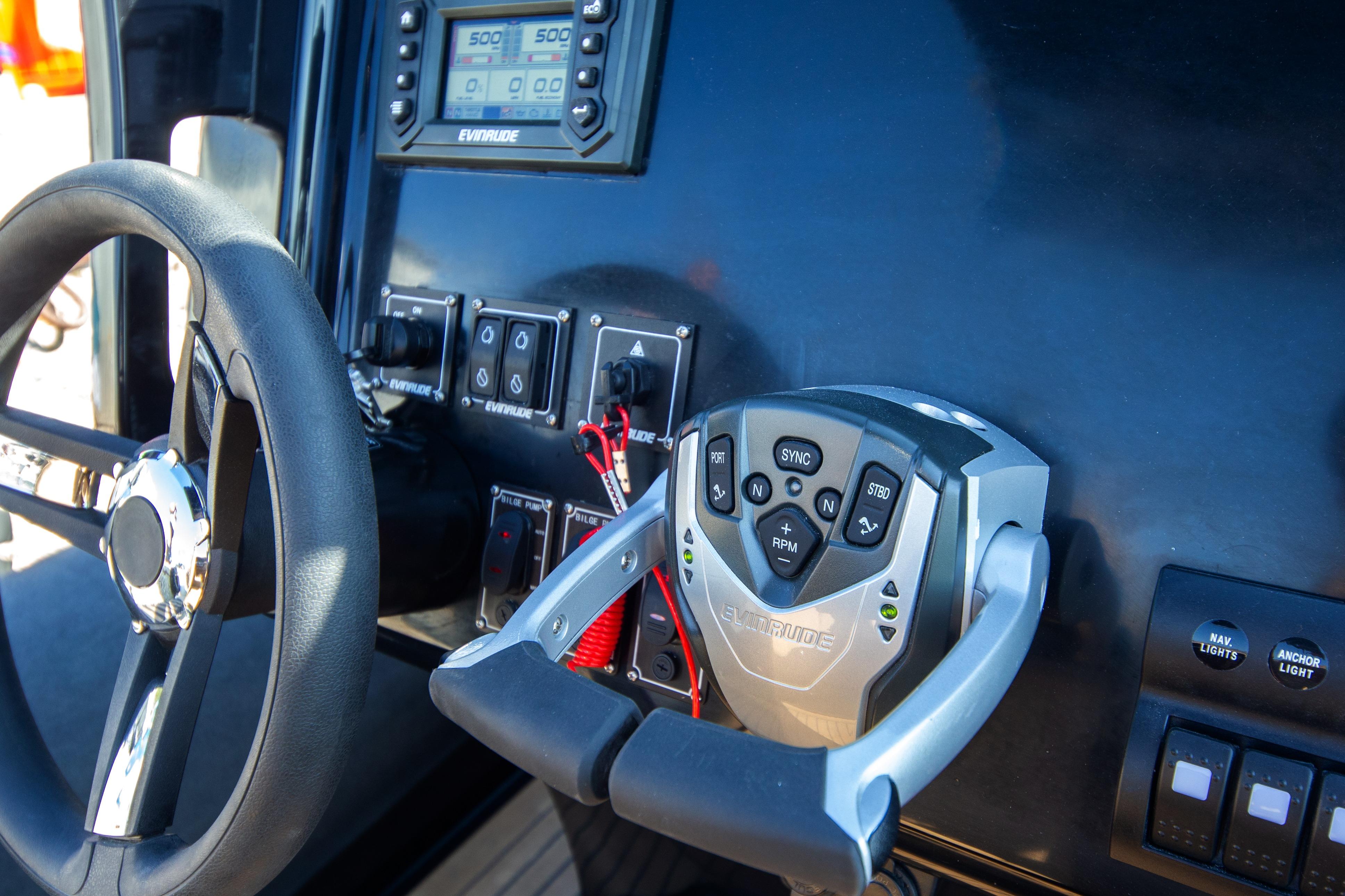 Control panel of 2022 Bering Marine BM28 CC boat with steering wheel and navigation controls.