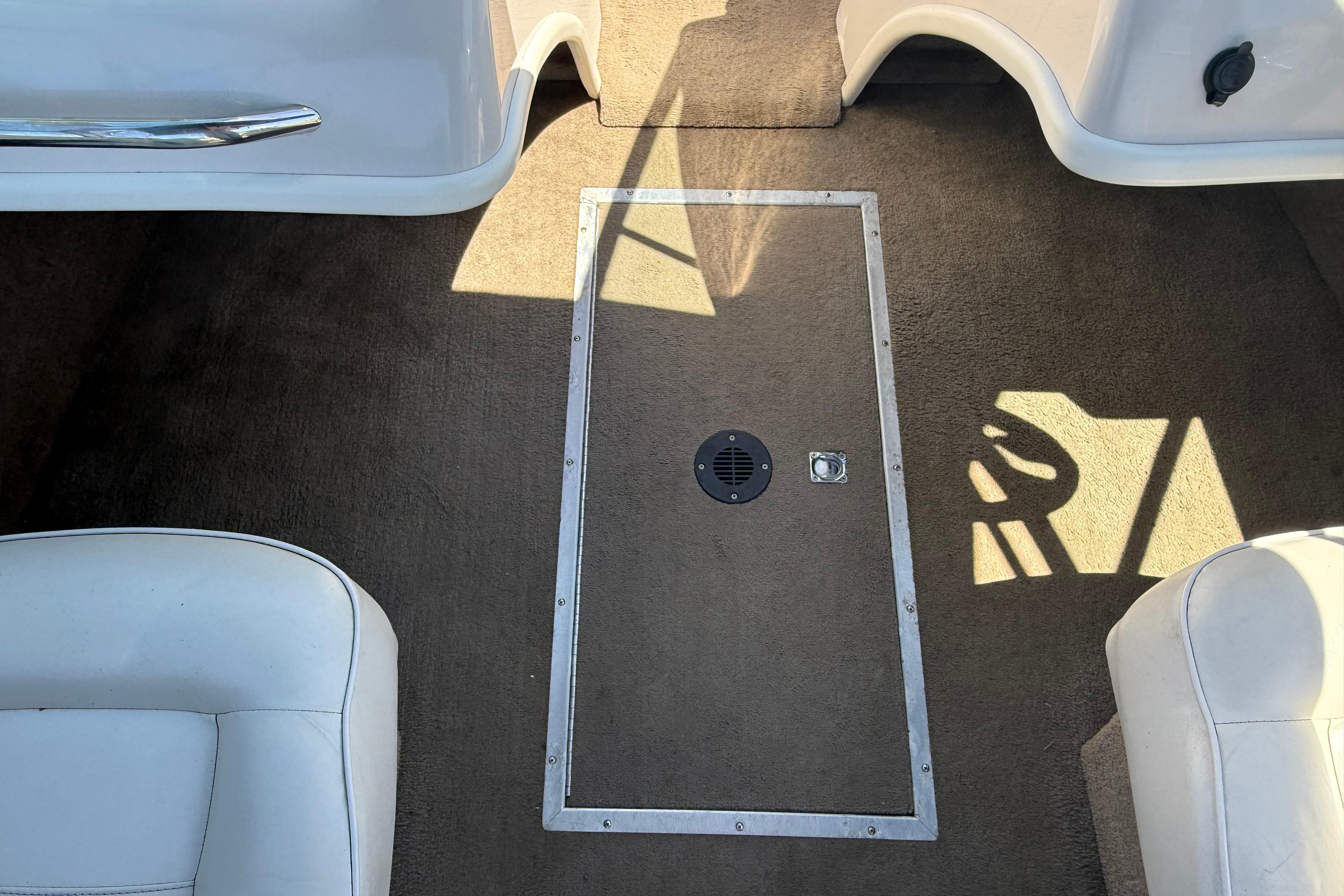 Interior of a 2011 Reinell 197 boat showing carpeted floor and seating.