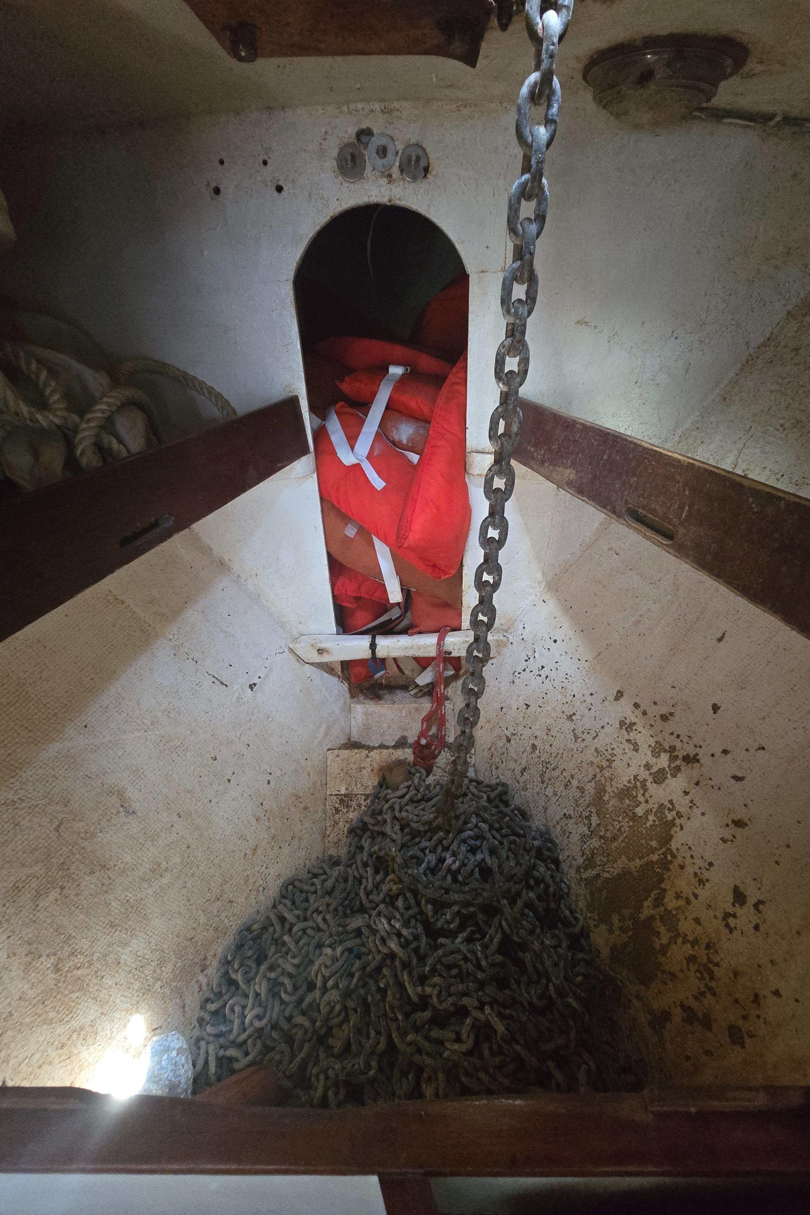 Anchor chain and life jackets in a 1978 Herreshoff 50 sailboat interior.