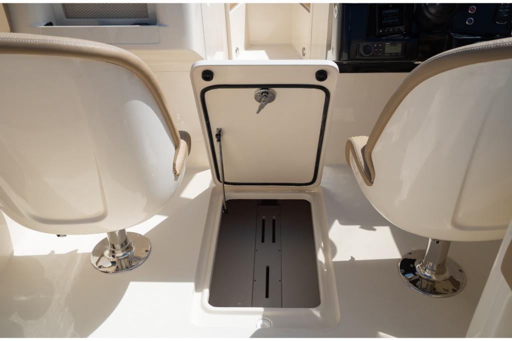 2023 Scout 240 Dorado boat interior with two seats and storage compartment.