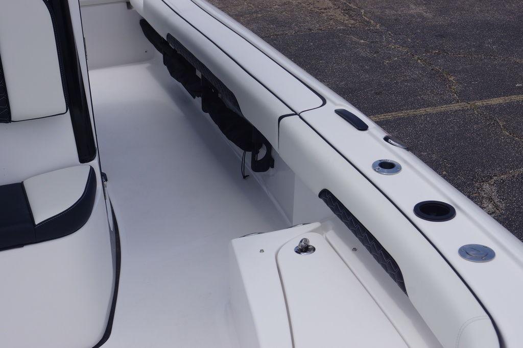 Interior view of 2027 Tidewater 2500 Carolina Bay boat, showcasing seating and rod holders.