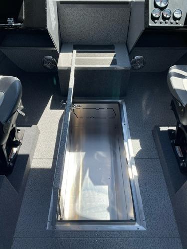 2024 Spartan 220 Maximus boat interior with open storage compartment.