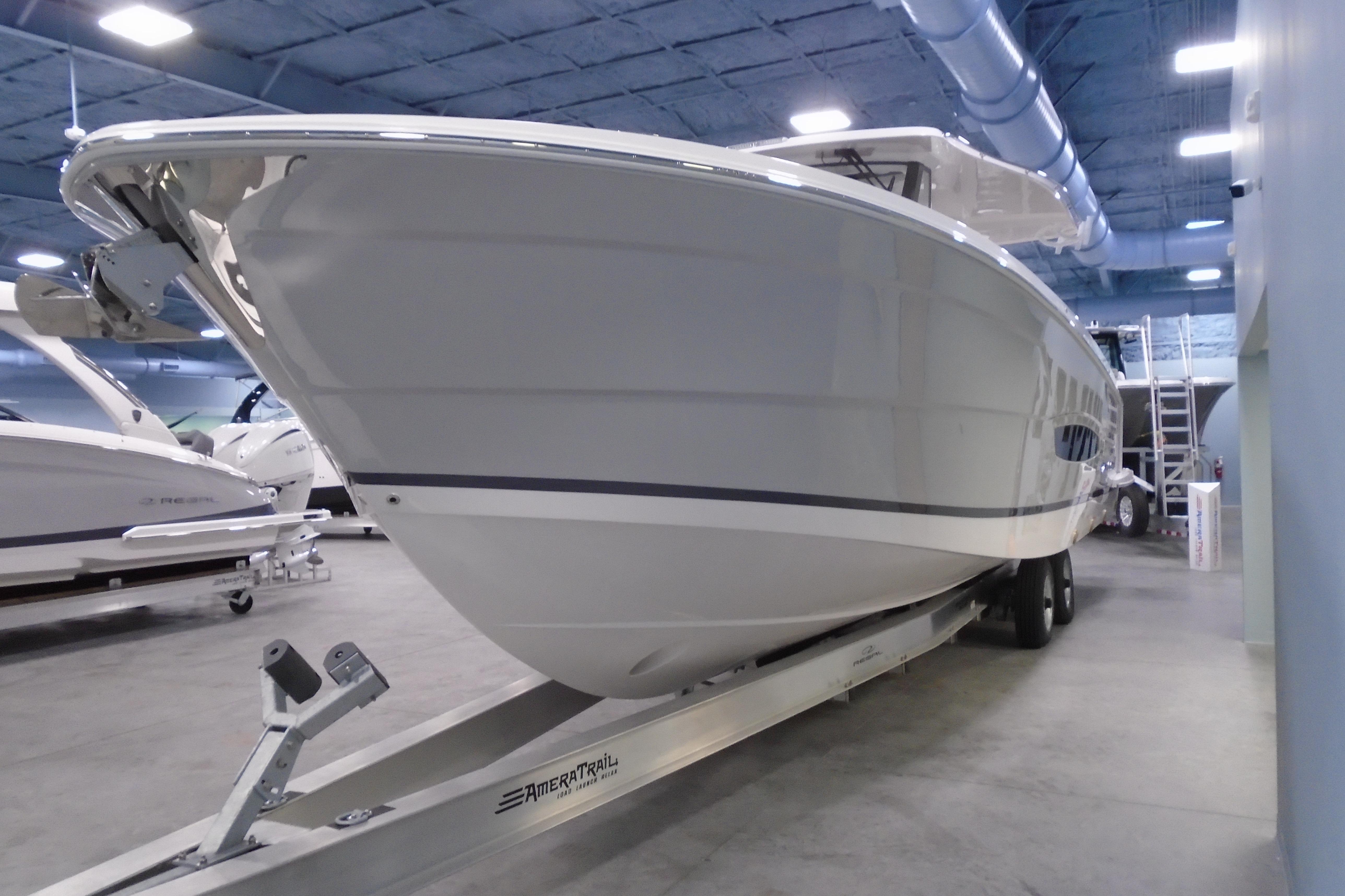 2026 Regal 38 SAV boat on trailer in indoor showroom.