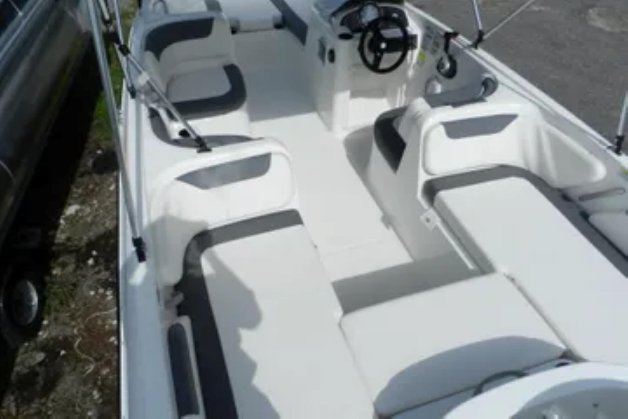 2026 Bayliner Element E18 boat interior with seating and steering wheel.