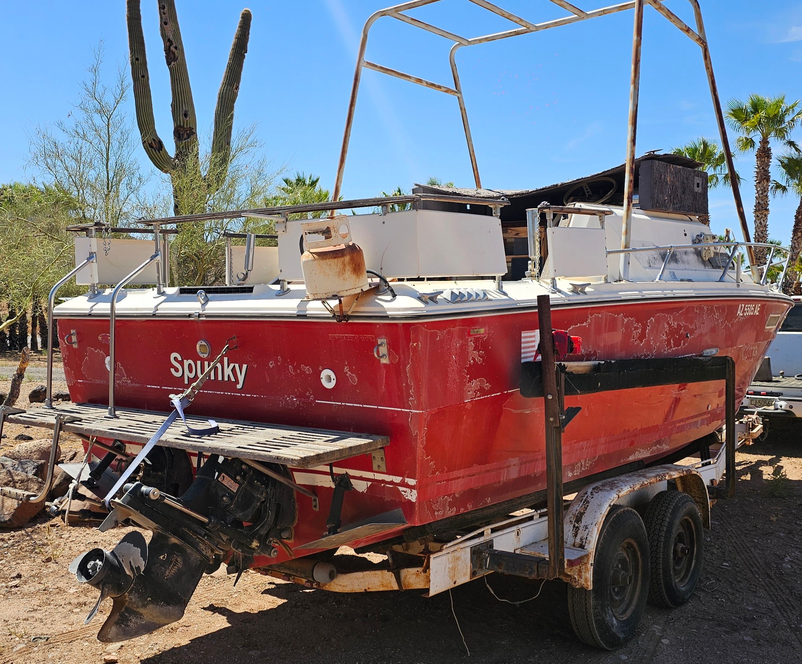 1975 Sea Ray Cabin Cruiser on trailer, red color, desert background.