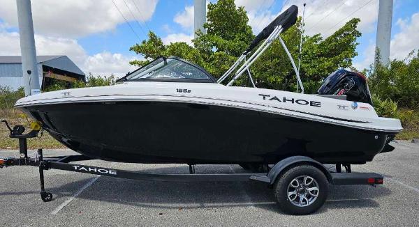2025 Tahoe 185 S boat on trailer, black and white design, parked outdoors.