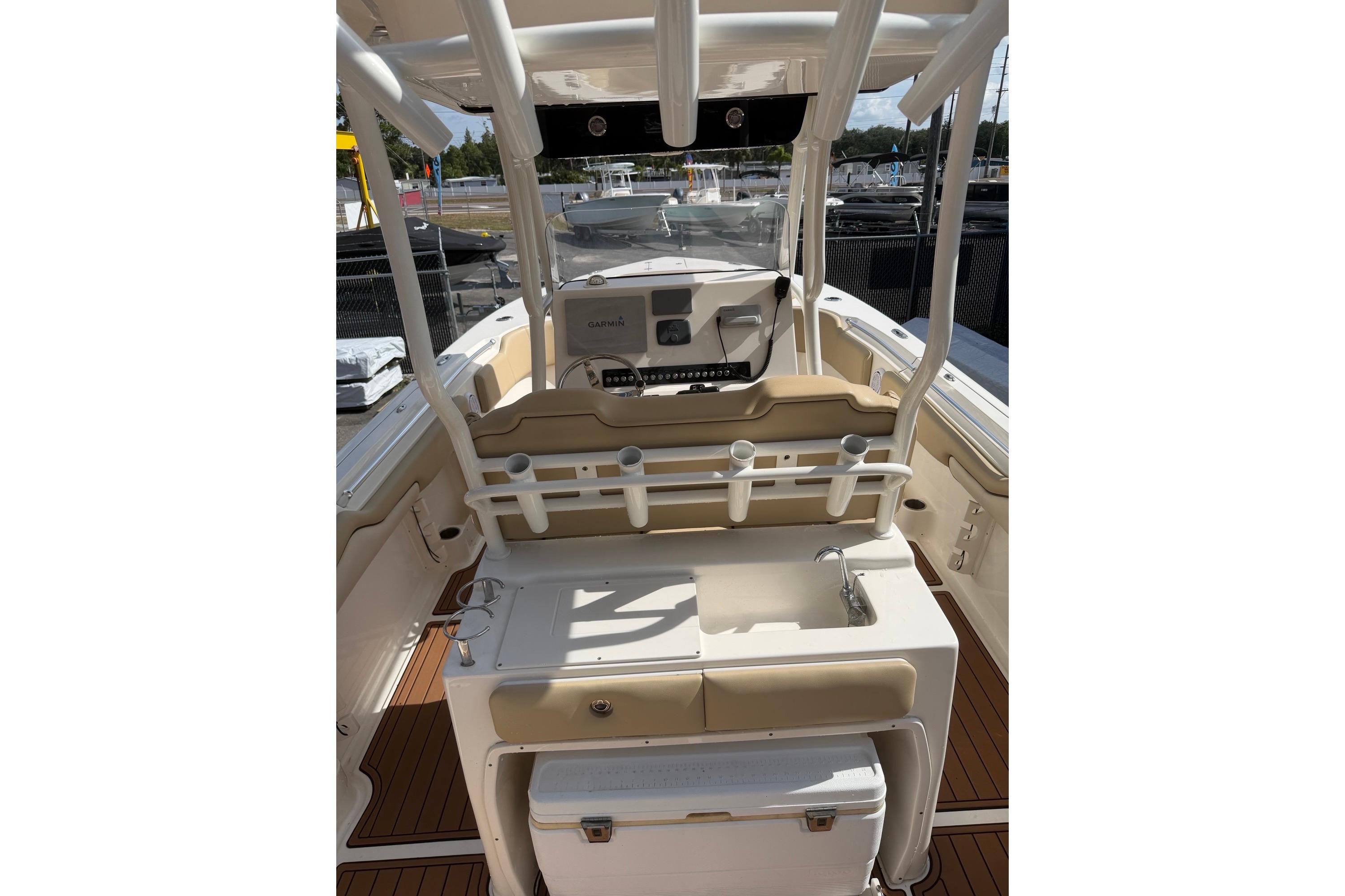 2019 Key West 263 FS boat interior with helm, seating, and storage compartments.
