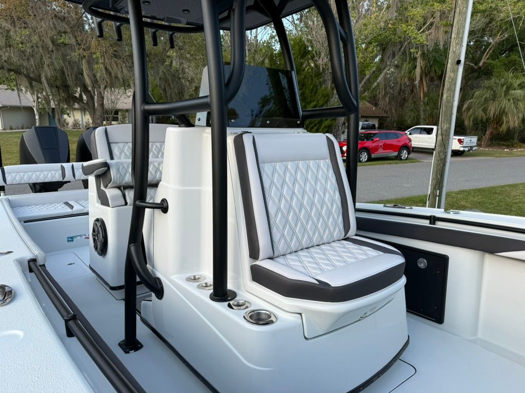 The image shows the cockpit of a 2020 Yellowfin 26 Hybrid boat with cushioned seating.