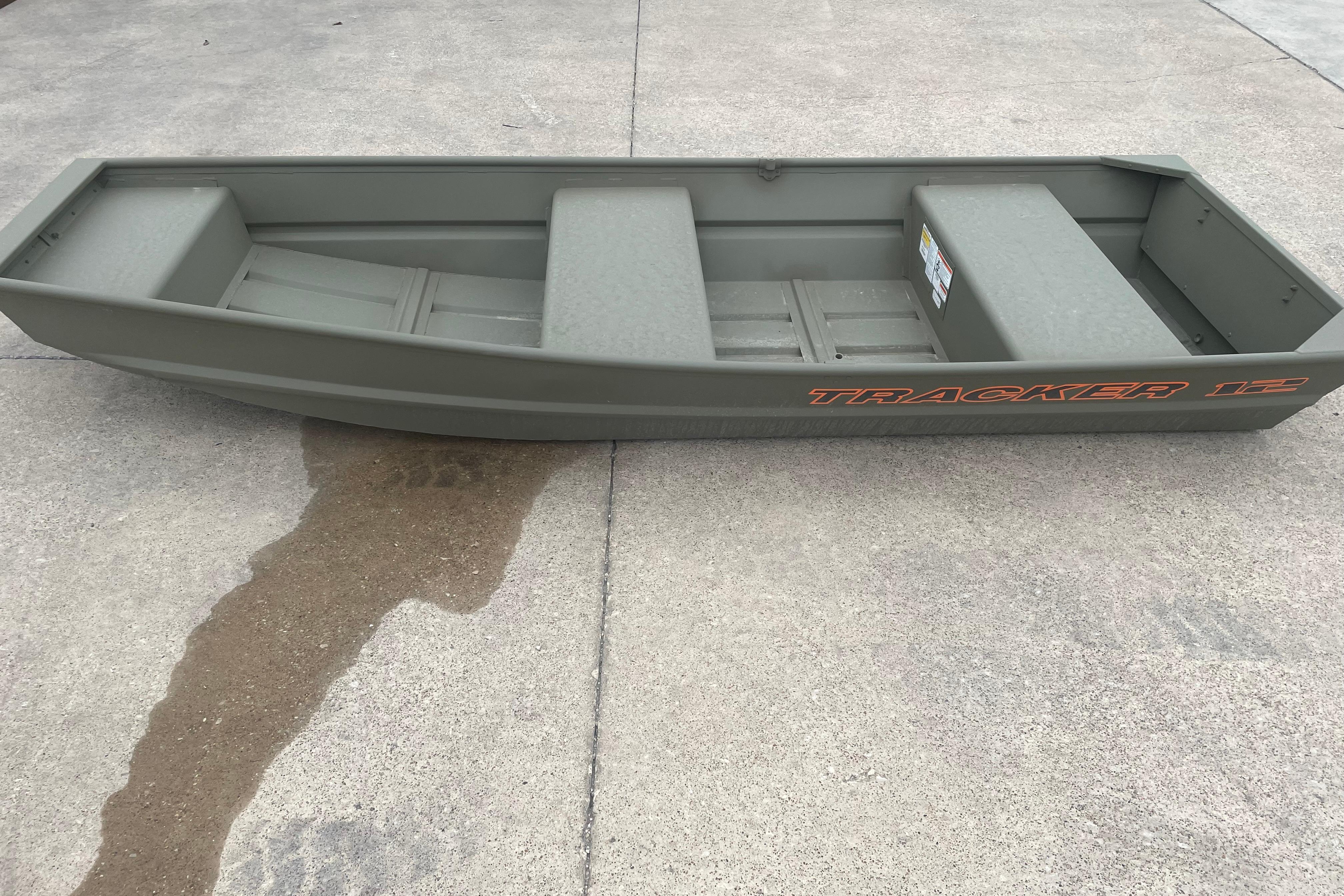 2026 Tracker Grizzly 12 Jon boat on concrete surface, side view.