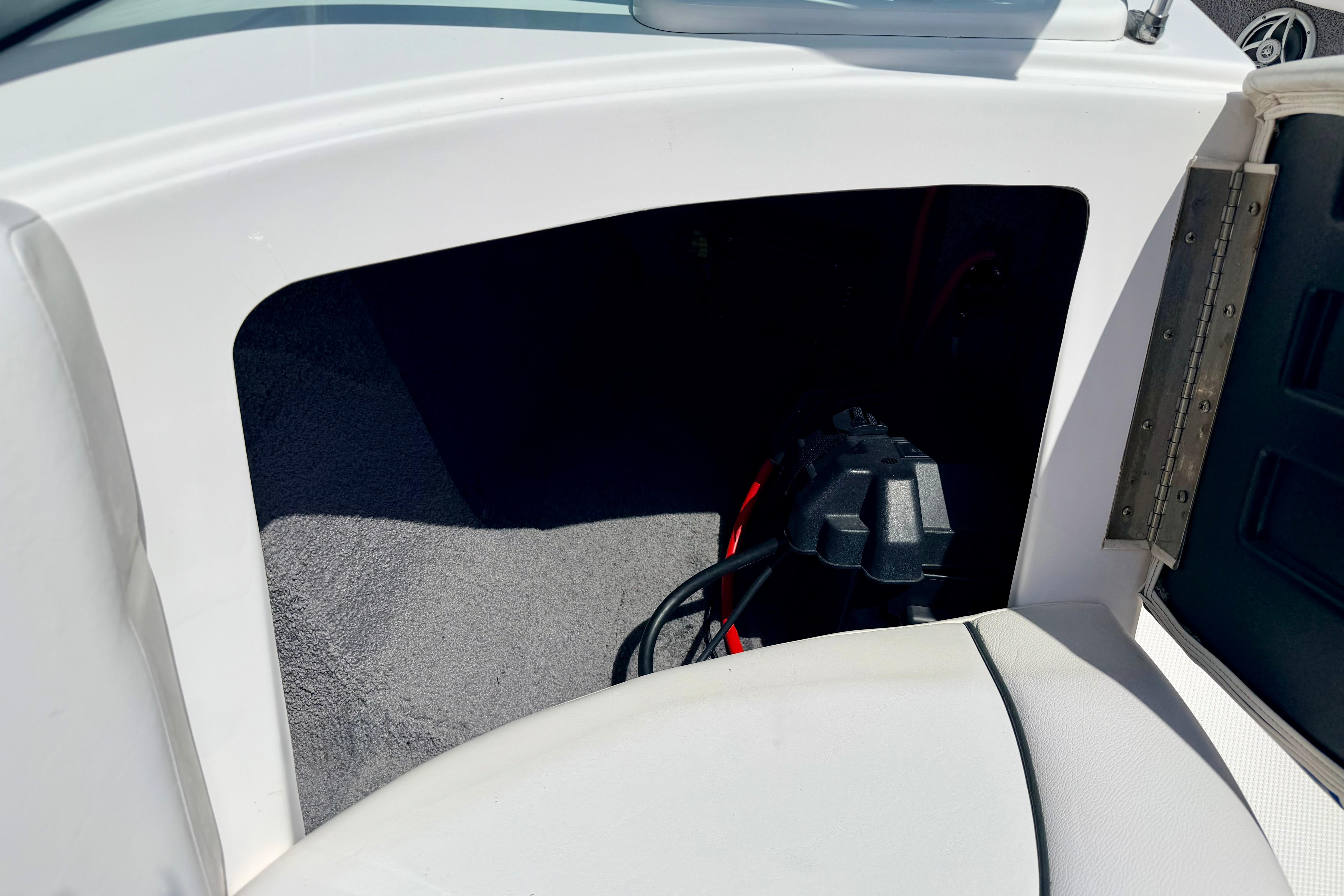 2008 Moomba Outback V storage compartment with visible wiring and carpeted interior.