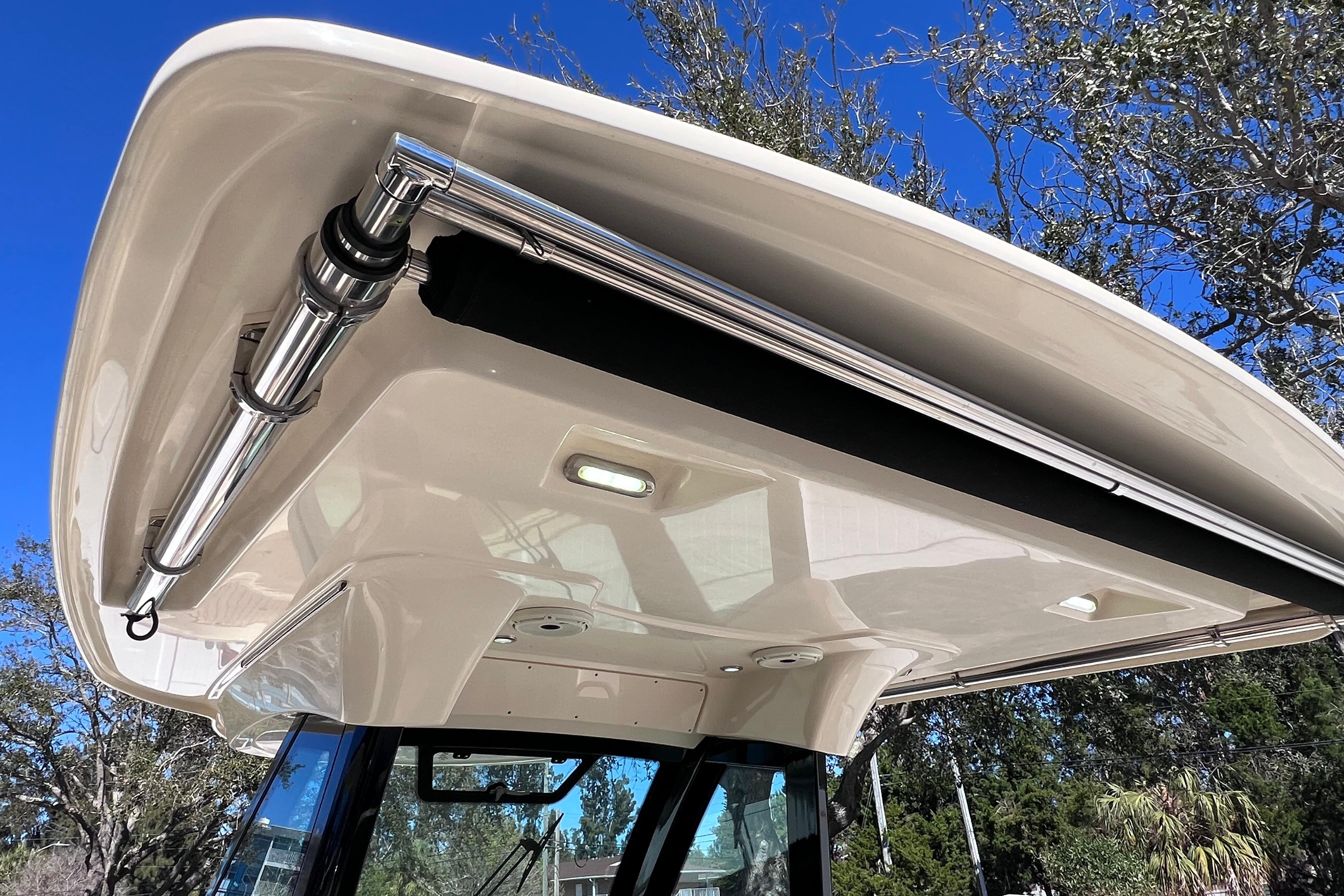 2022 Chris-Craft Catalina 30 boat canopy with stainless steel fittings under clear blue sky.