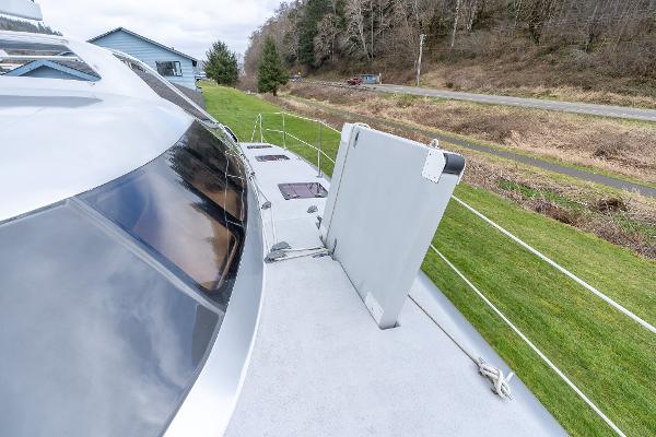 2025 Shuttleworth 52 AeroRig yacht deck with sleek design and scenic background.