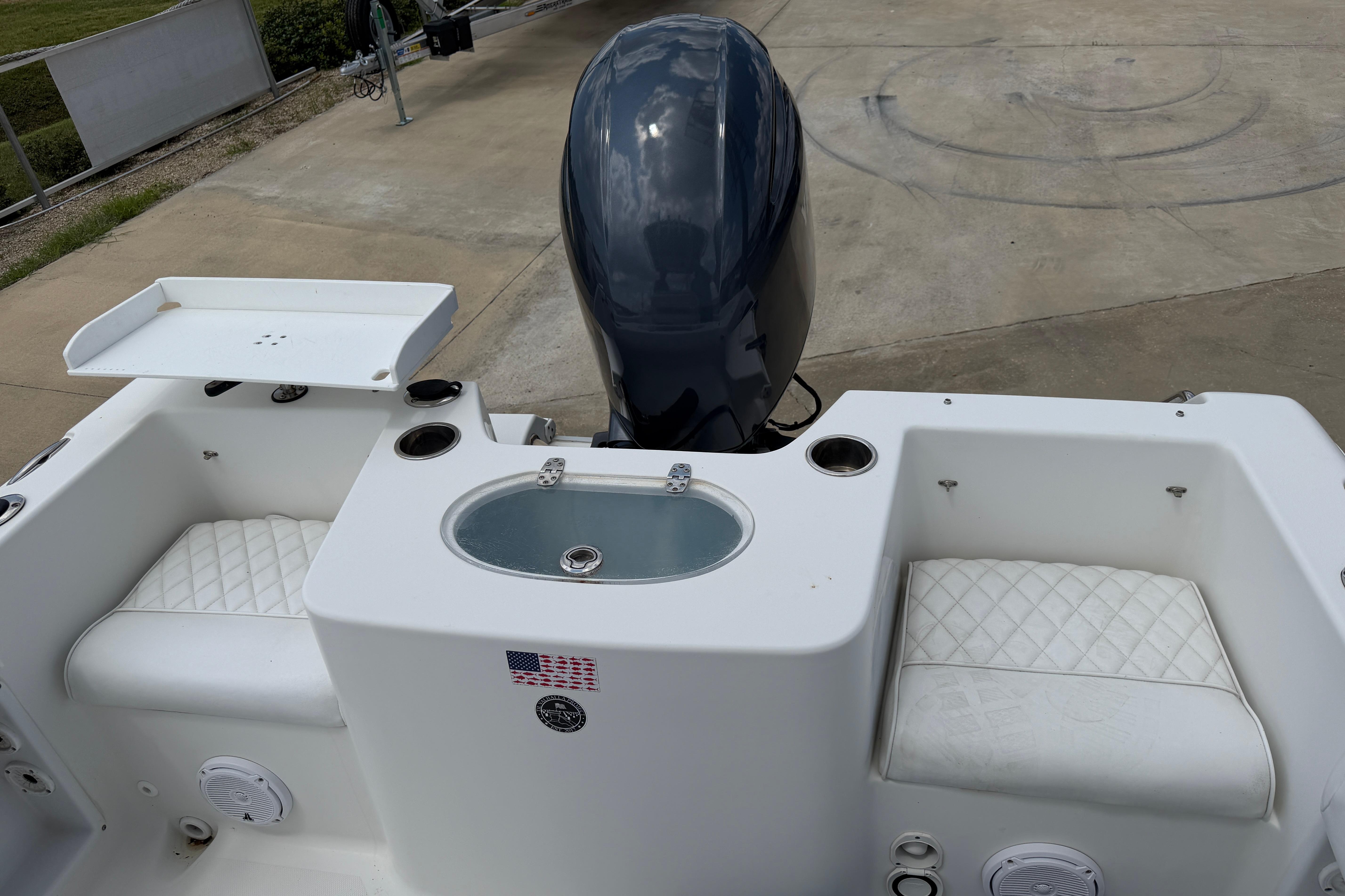 2015 Sea Hunt Triton 225 boat interior with seating and engine view.
