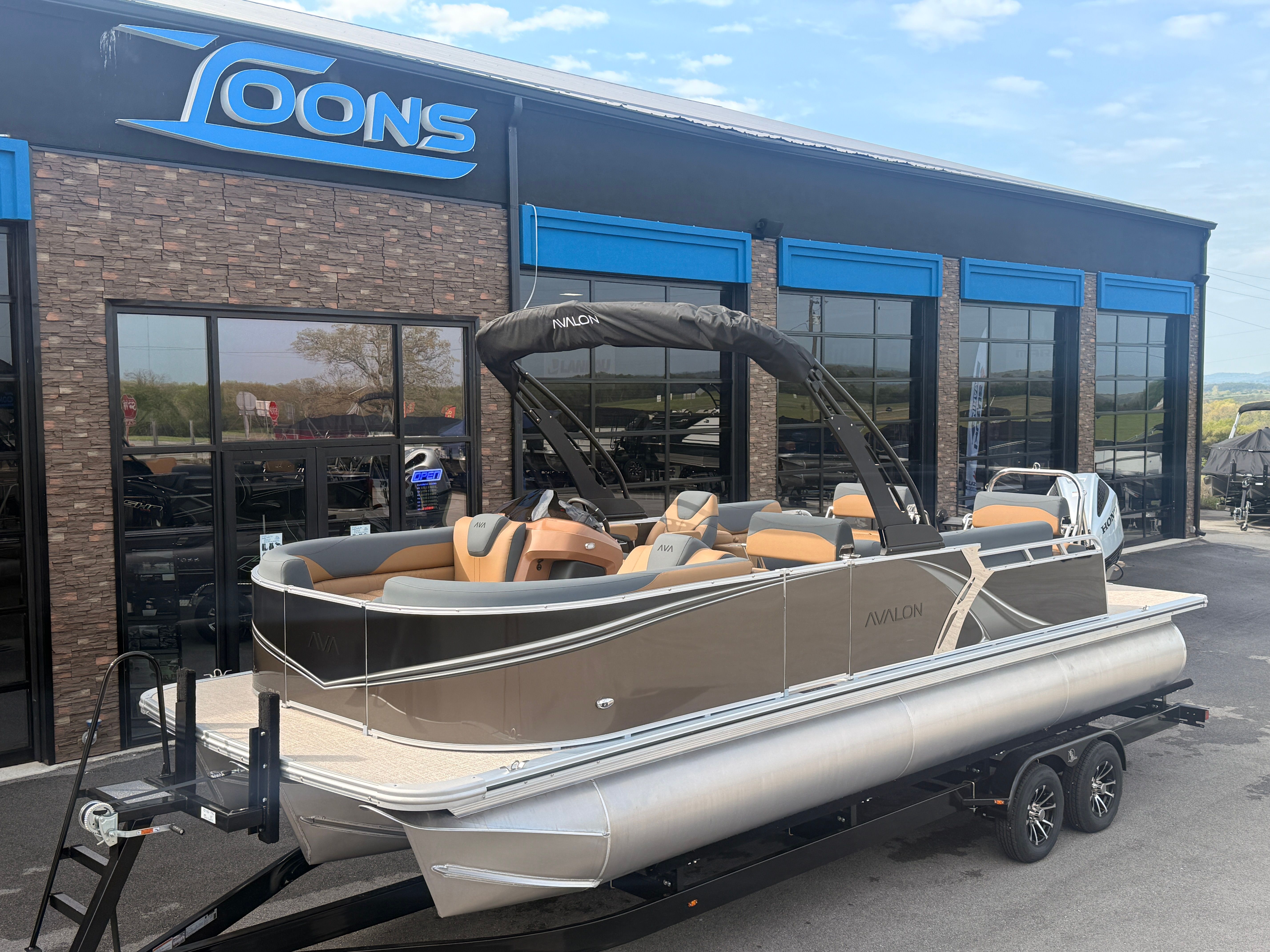 2026 Avalon 2385 LSZ pontoon boat outside a showroom.