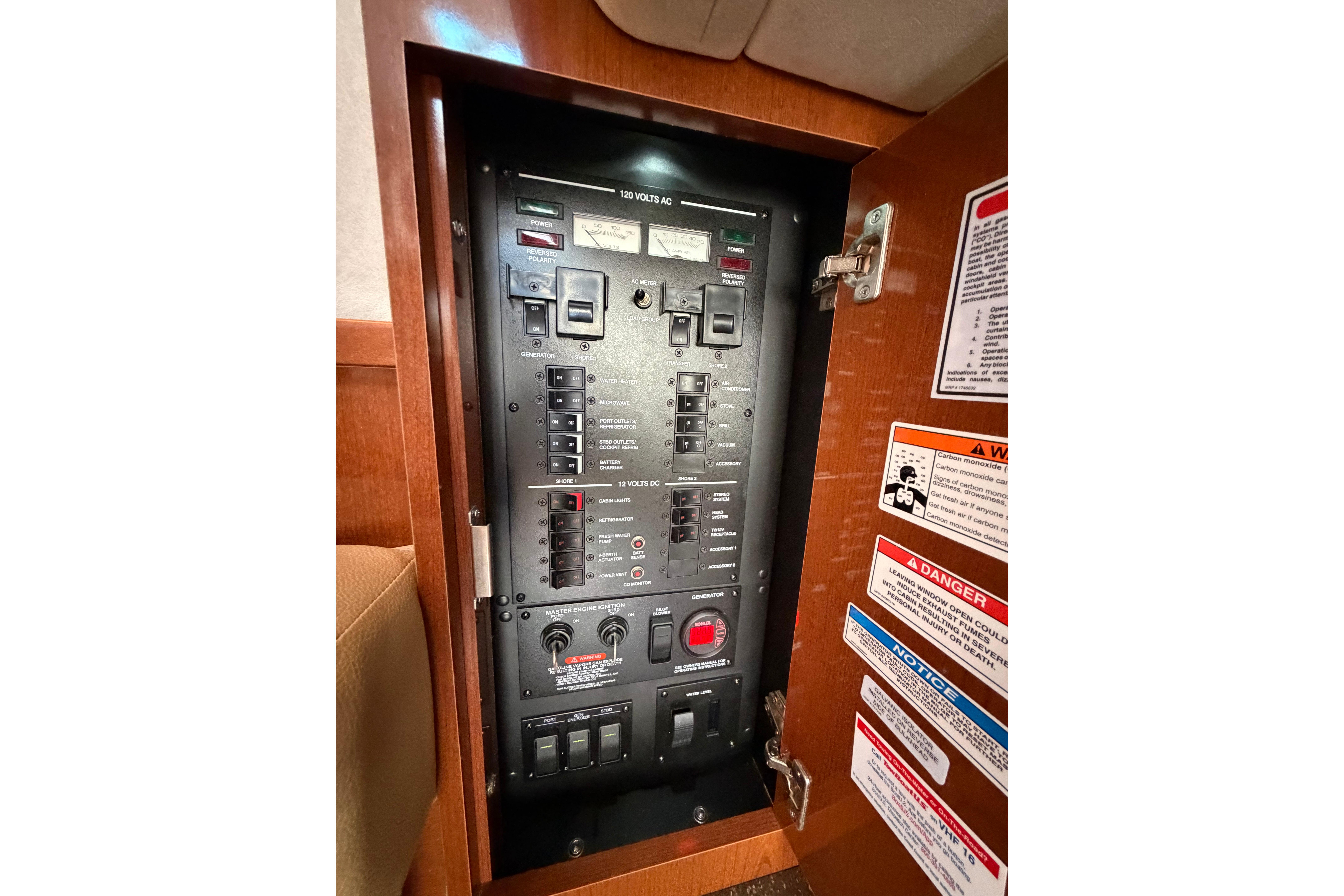 Electrical panel inside a 2012 Sea Ray Sundancer 370 yacht, featuring switches and warnings.