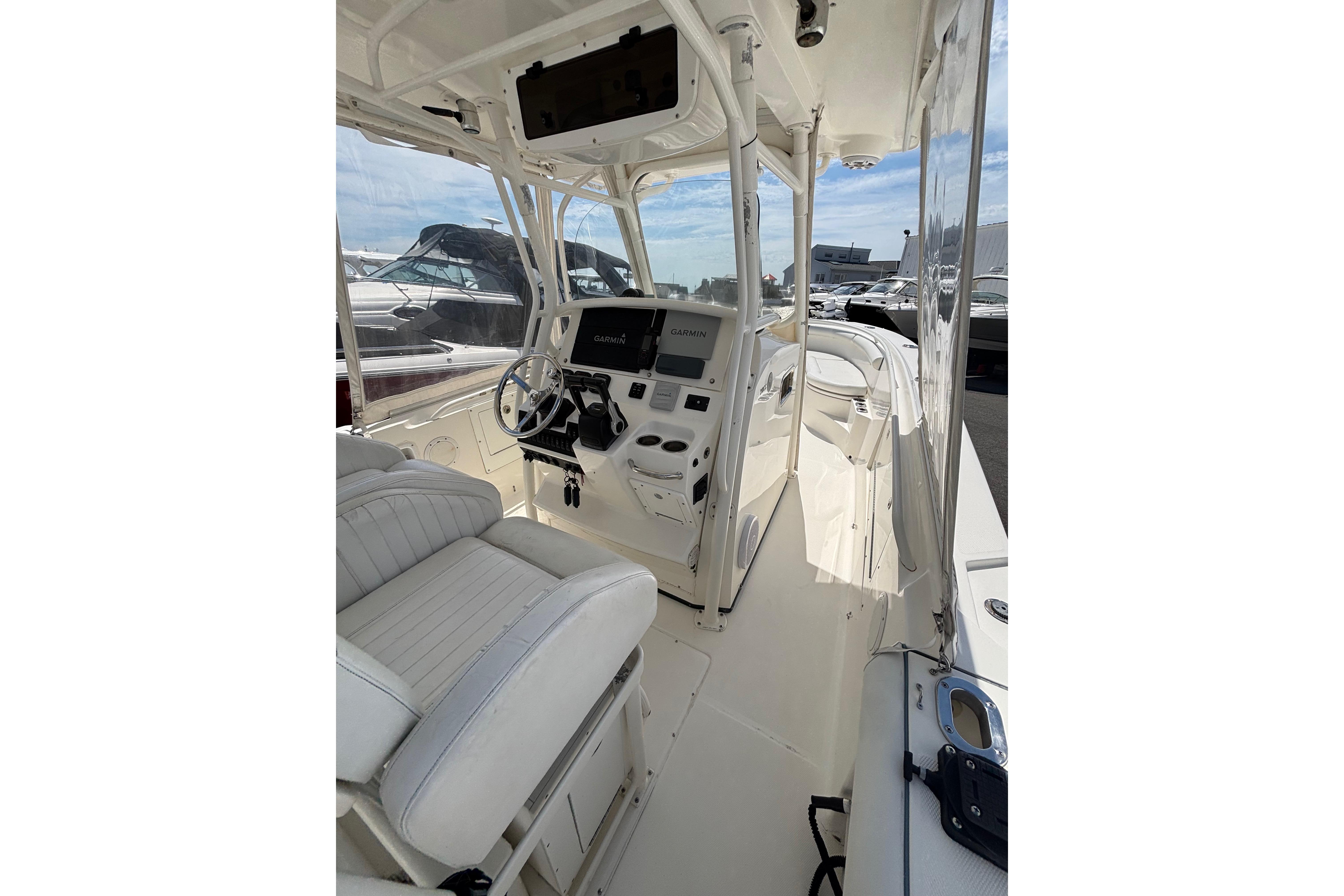 Interior view of a 2006 Edgewater 318CC boat, featuring a modern helm and seating.