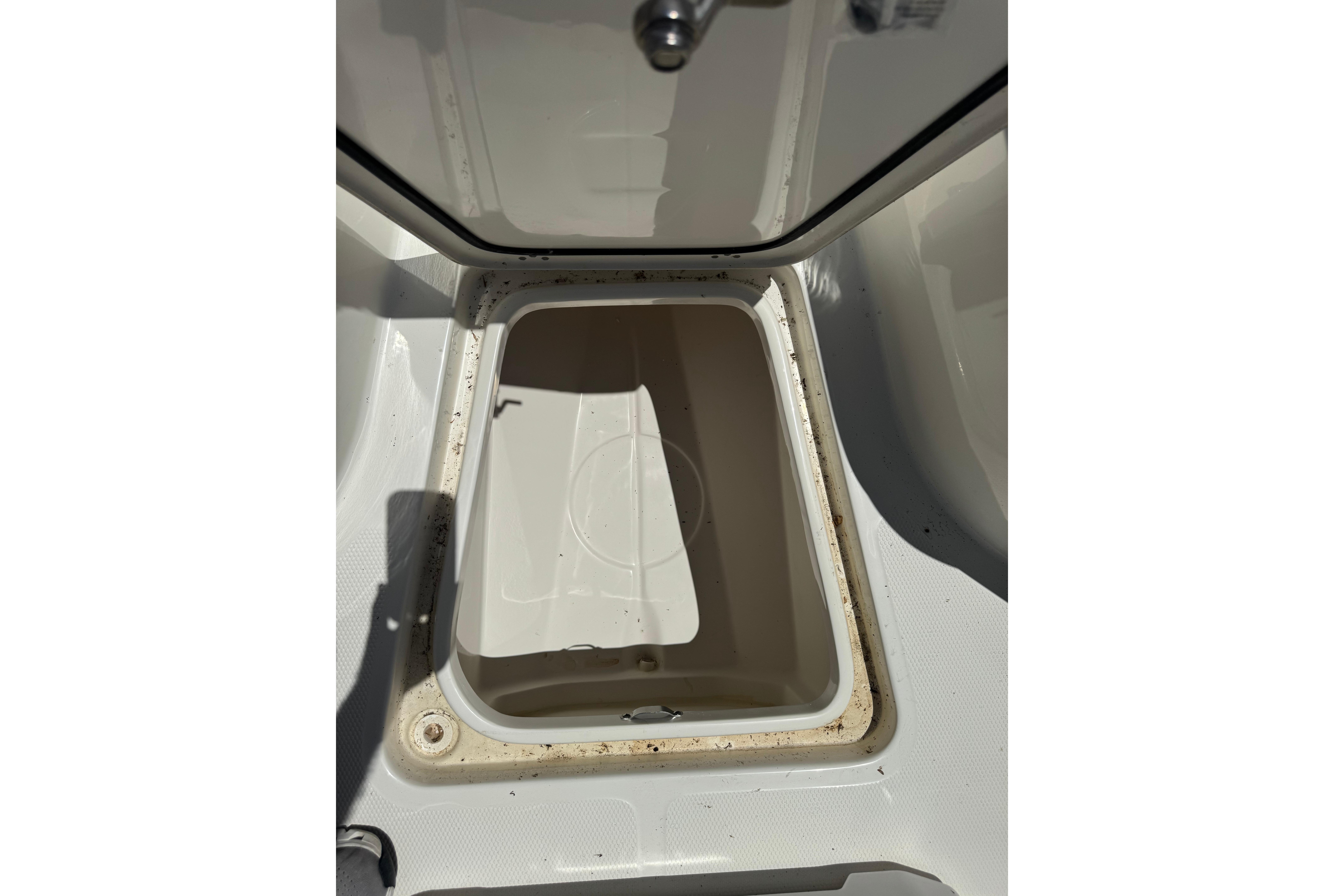 Open storage compartment on 2026 Mako 214 Center Console boat.