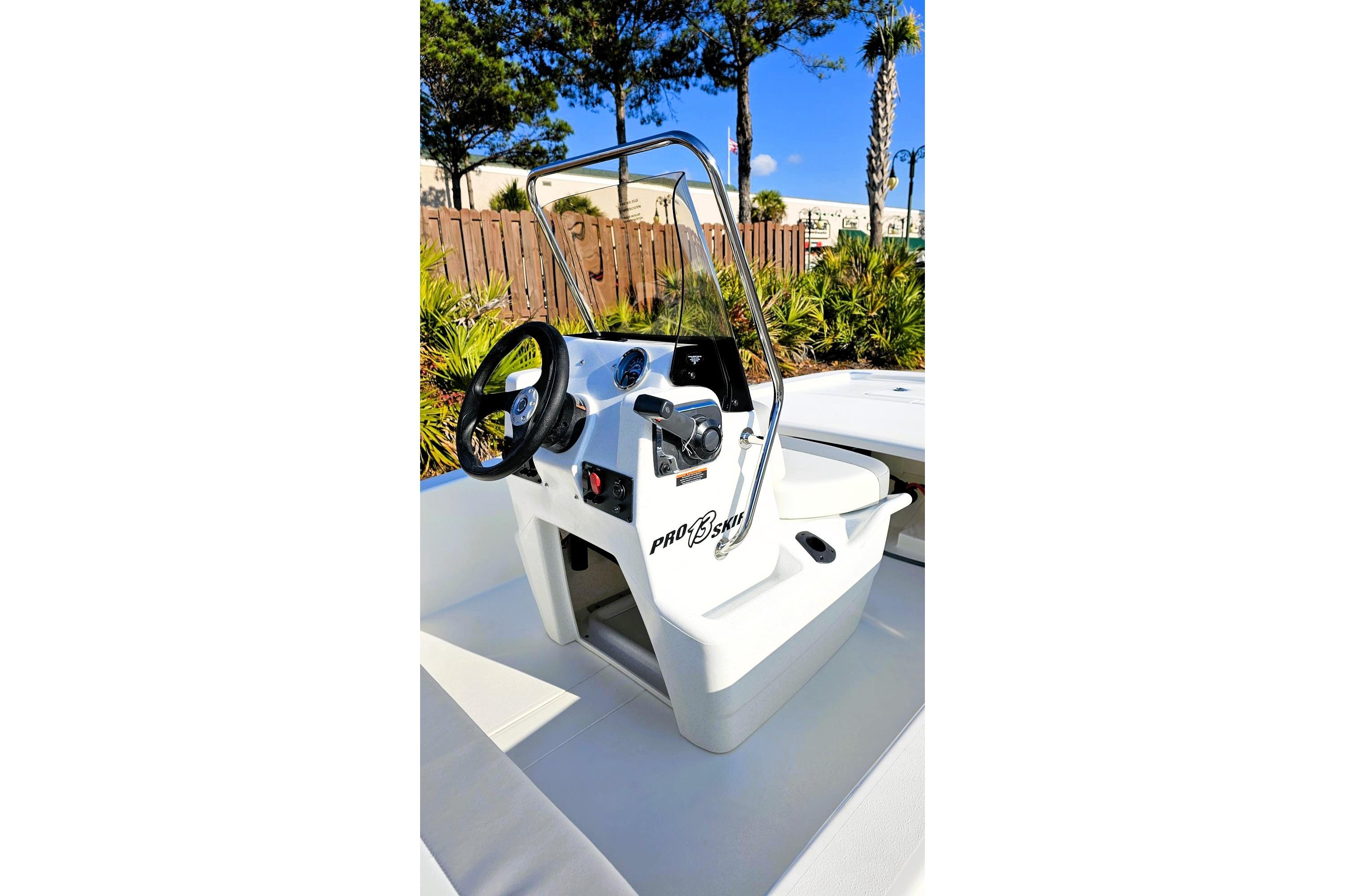 2026 Mako Pro Skiff 13 CC boat console with steering wheel and controls.
