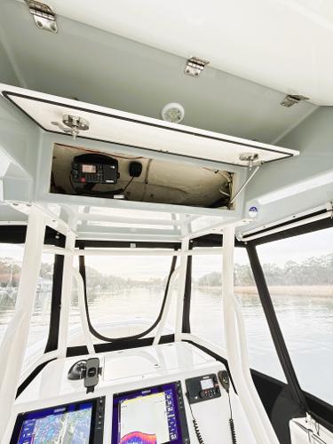 2016 Cobia 296 Center Console boat interior with navigation equipment and storage compartment.