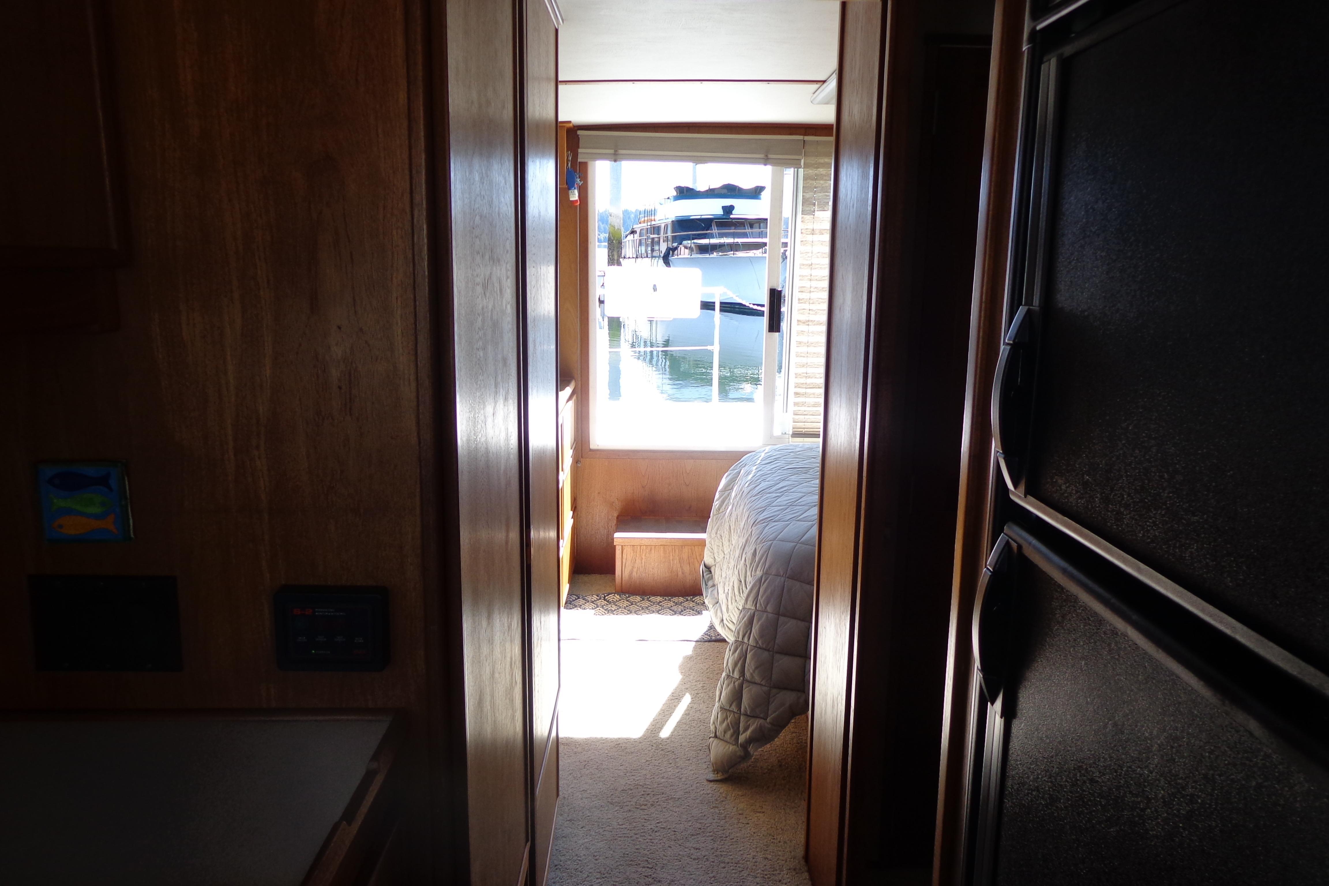 Interior view of 1992 Cruise-A-Home Corsair 4200, featuring a cozy bedroom and window.