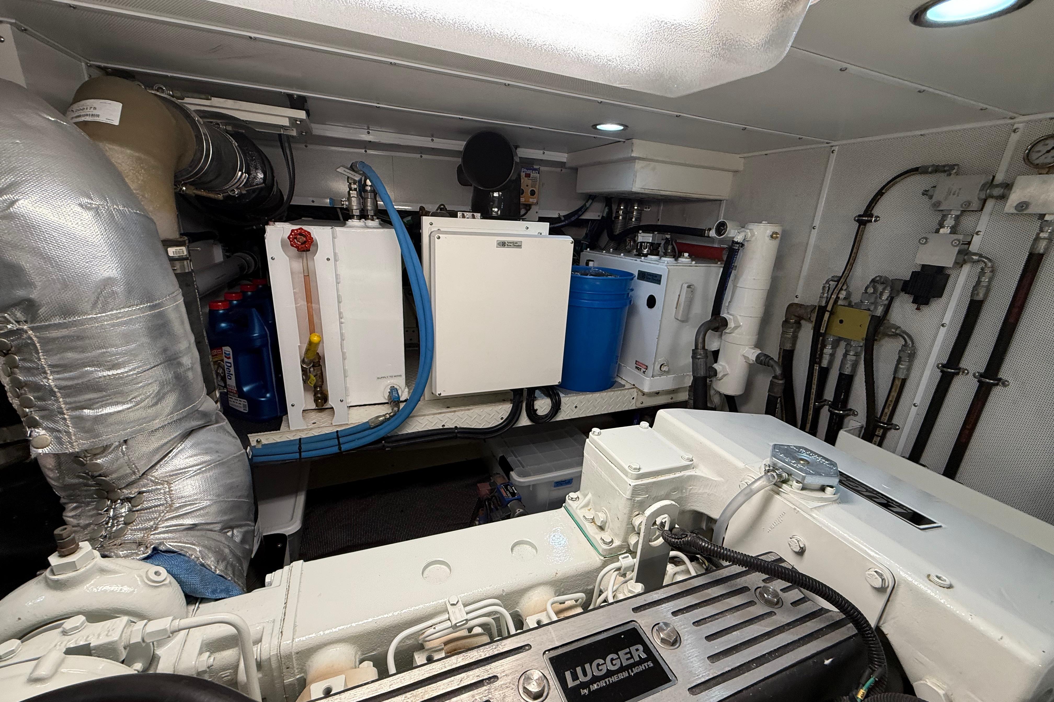 Engine room of a 2009 Nordhavn N64 yacht, featuring Lugger engine and various mechanical components.