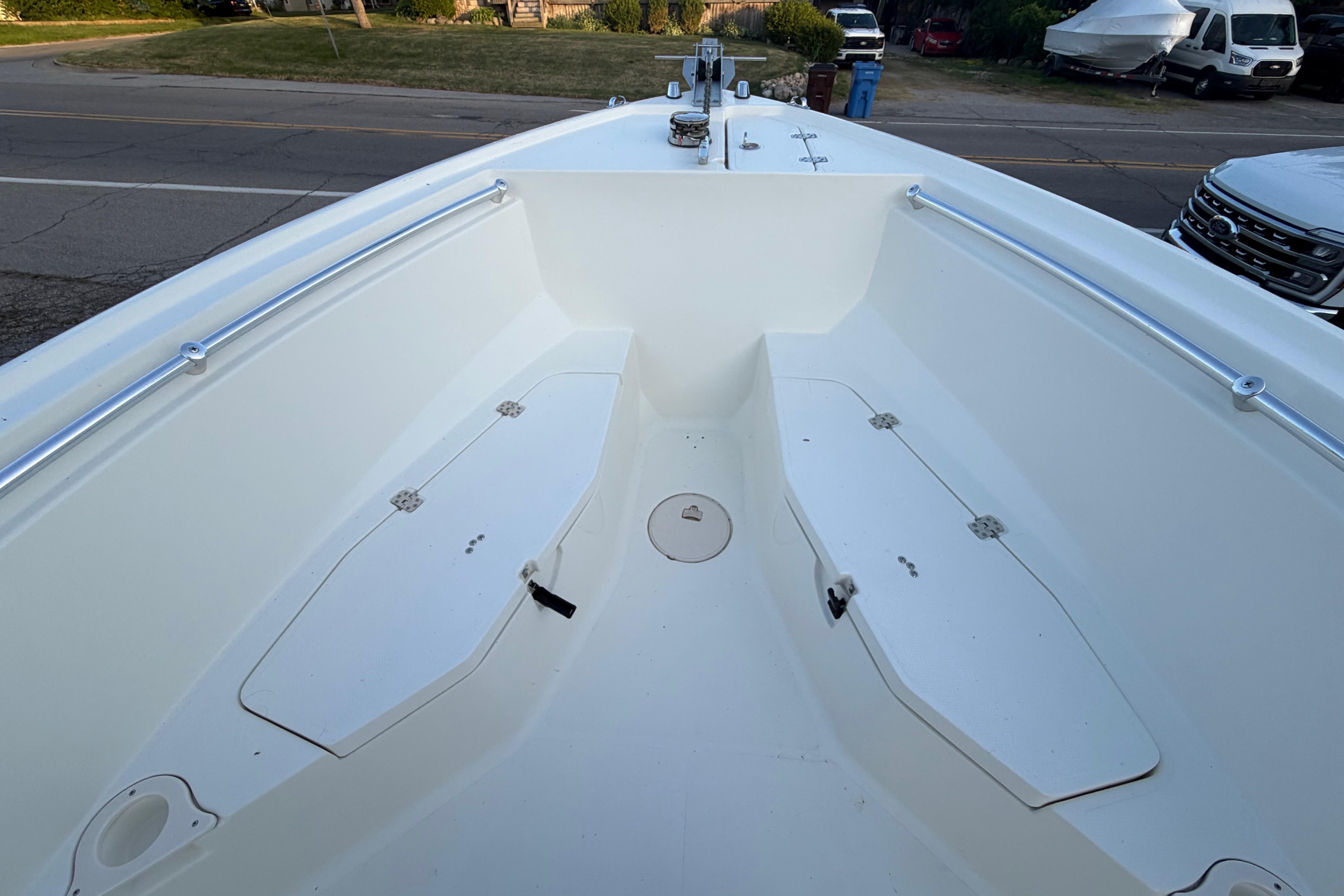 2007 Mako 234 Center Console boat interior with storage compartments and clean white deck.