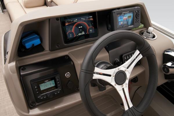 2024 Sun Tracker SportFish 22 DLX dashboard with steering wheel and electronic displays.