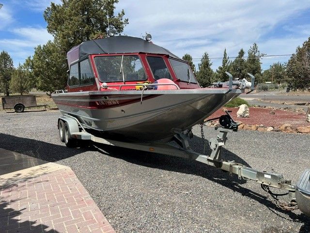 1996 Northwest Signature boat parked on trailer outdoors.