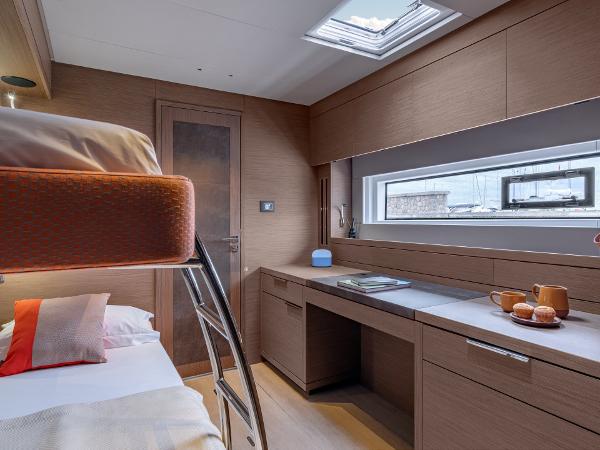 Luxurious interior of 2025 Lagoon SIXTY 7 yacht with modern bunk beds and sleek design.
