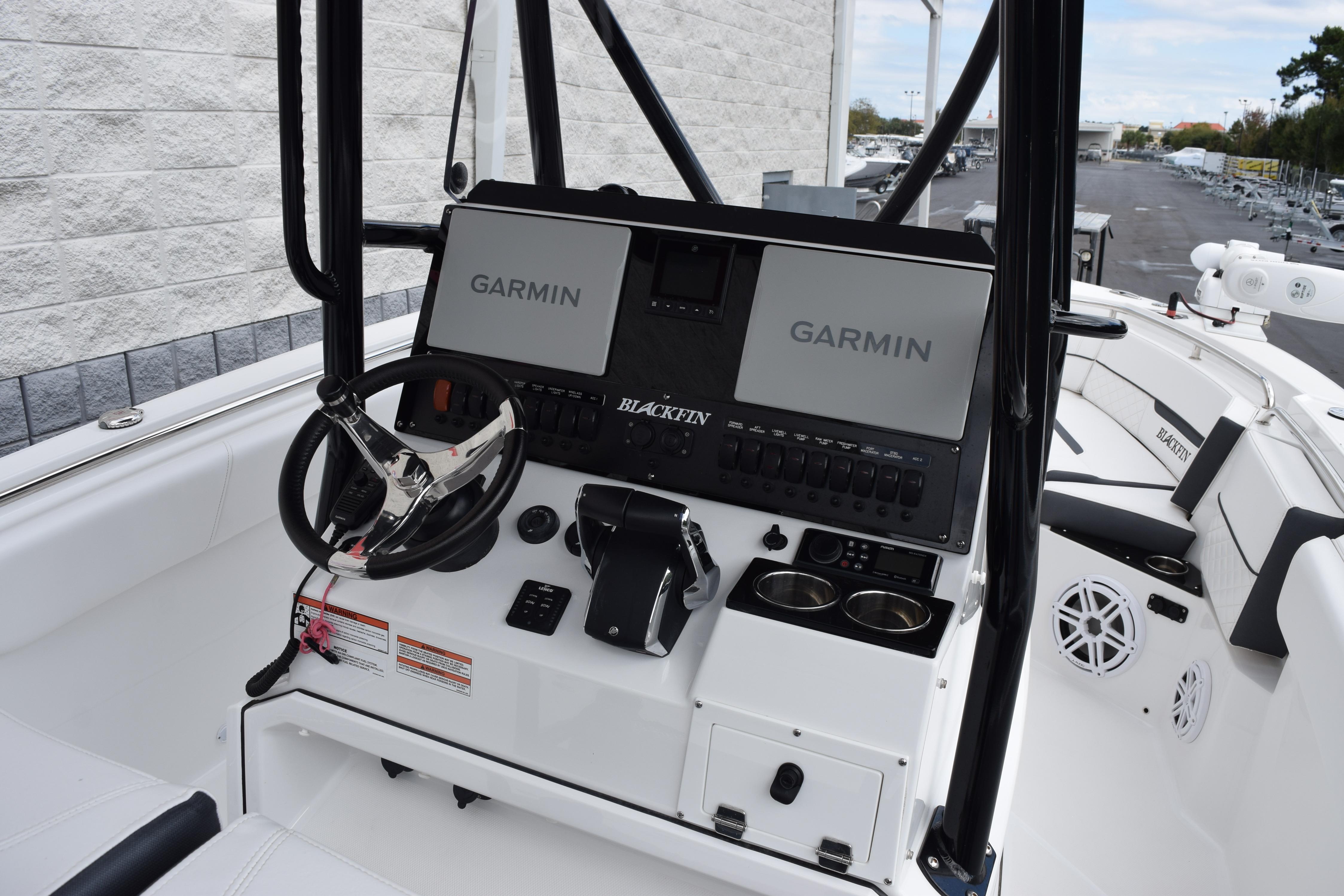 2023 Blackfin 252 CC boat dashboard with Garmin displays and steering wheel.