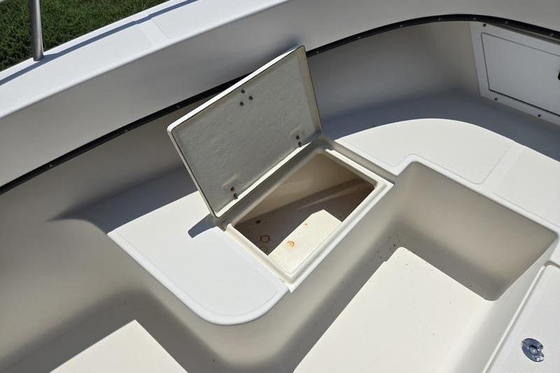 Open storage compartment on a 2000 May-Craft 2000CC boat deck.