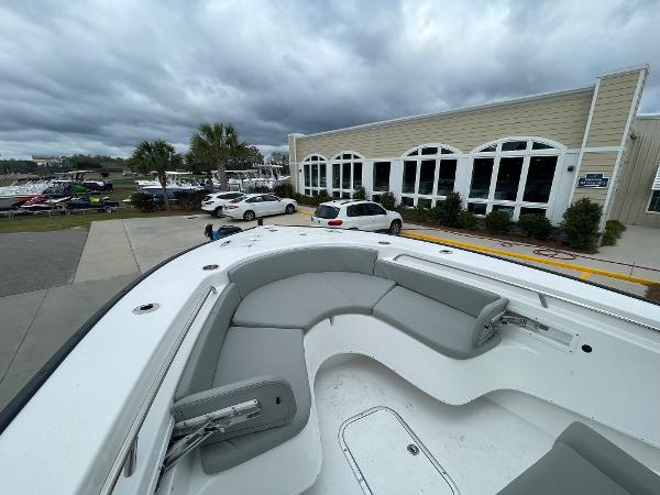 2026 Cape Horn 24XS boat with sleek seating, parked near a modern building.