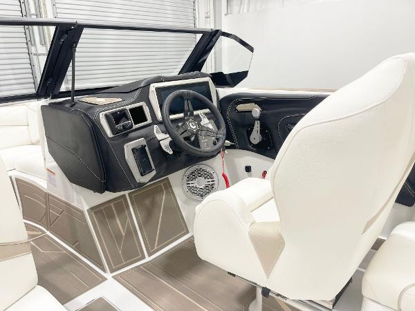 2025 Centurion NV213 boat interior with modern dashboard and white seating.
