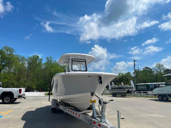 2023 Robalo R270 boat on trailer under blue sky.