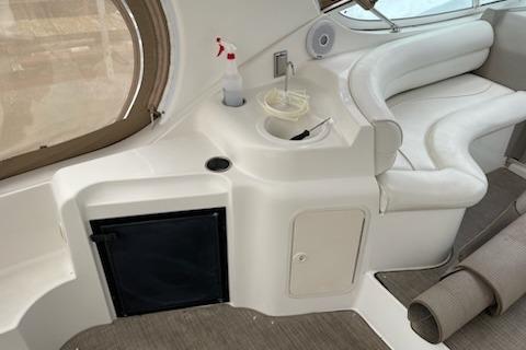 2002 Cruisers Yachts 3372 Express interior with seating and storage.