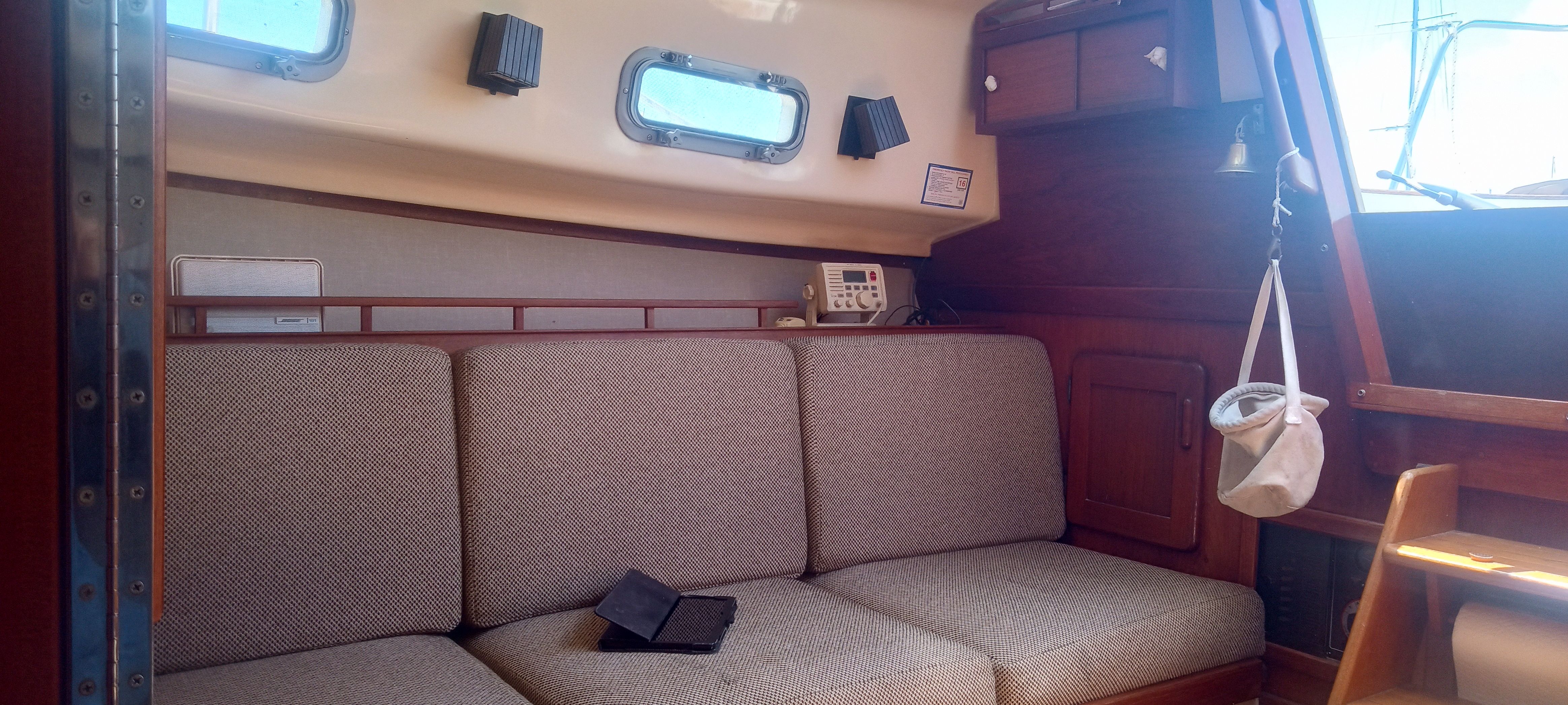 Interior of a 1983 Island Packet MKII yacht with cozy seating area.
