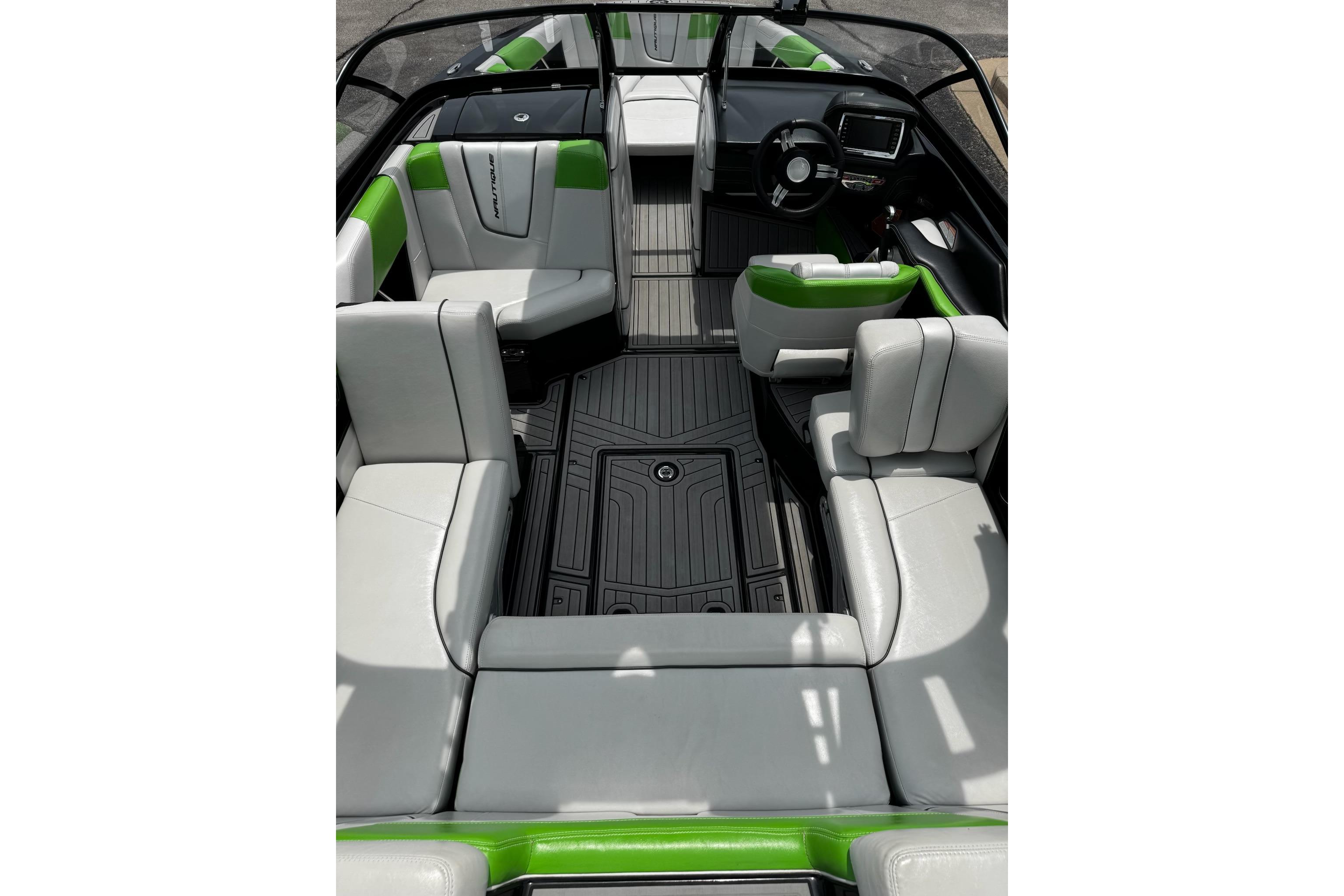 2014 Nautique Super Air Nautique G21 interior with gray and green seating, sleek design.