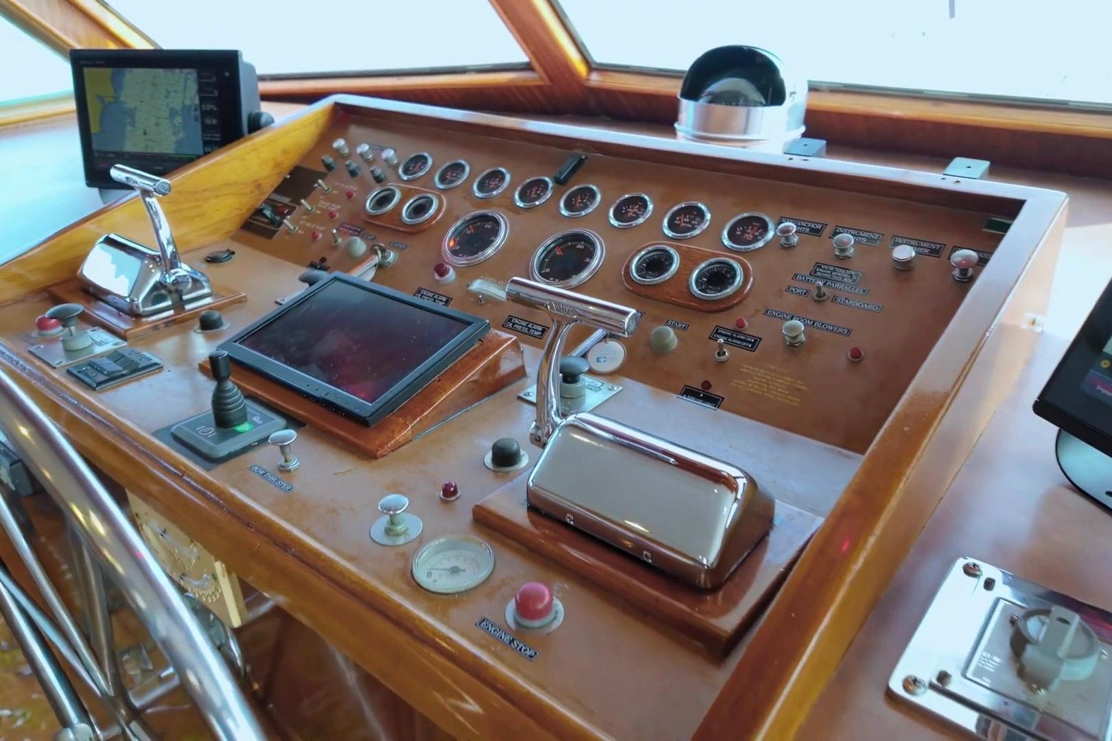 Control panel of a 1980 Hatteras 70 Motor Yacht with gauges and navigation equipment.