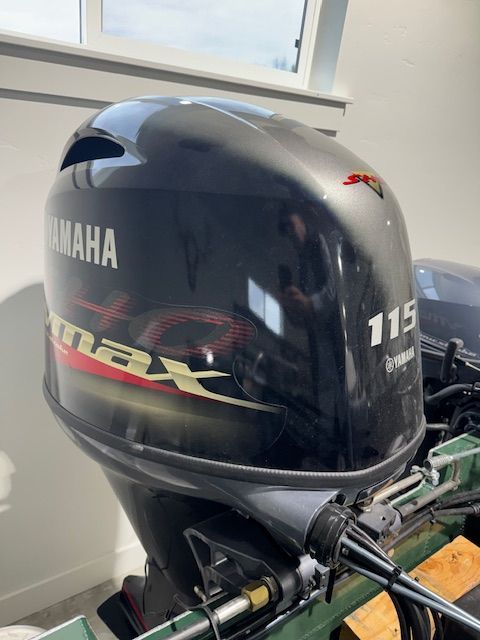 Yamaha 115 HP outboard motor in a garage.