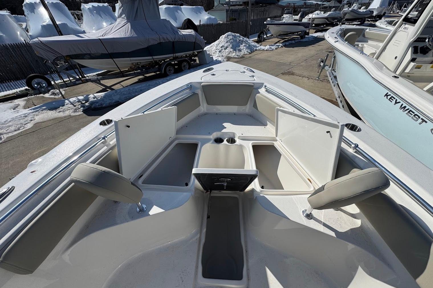 2026 Key West 239 FS boat interior with open storage compartments and seating.