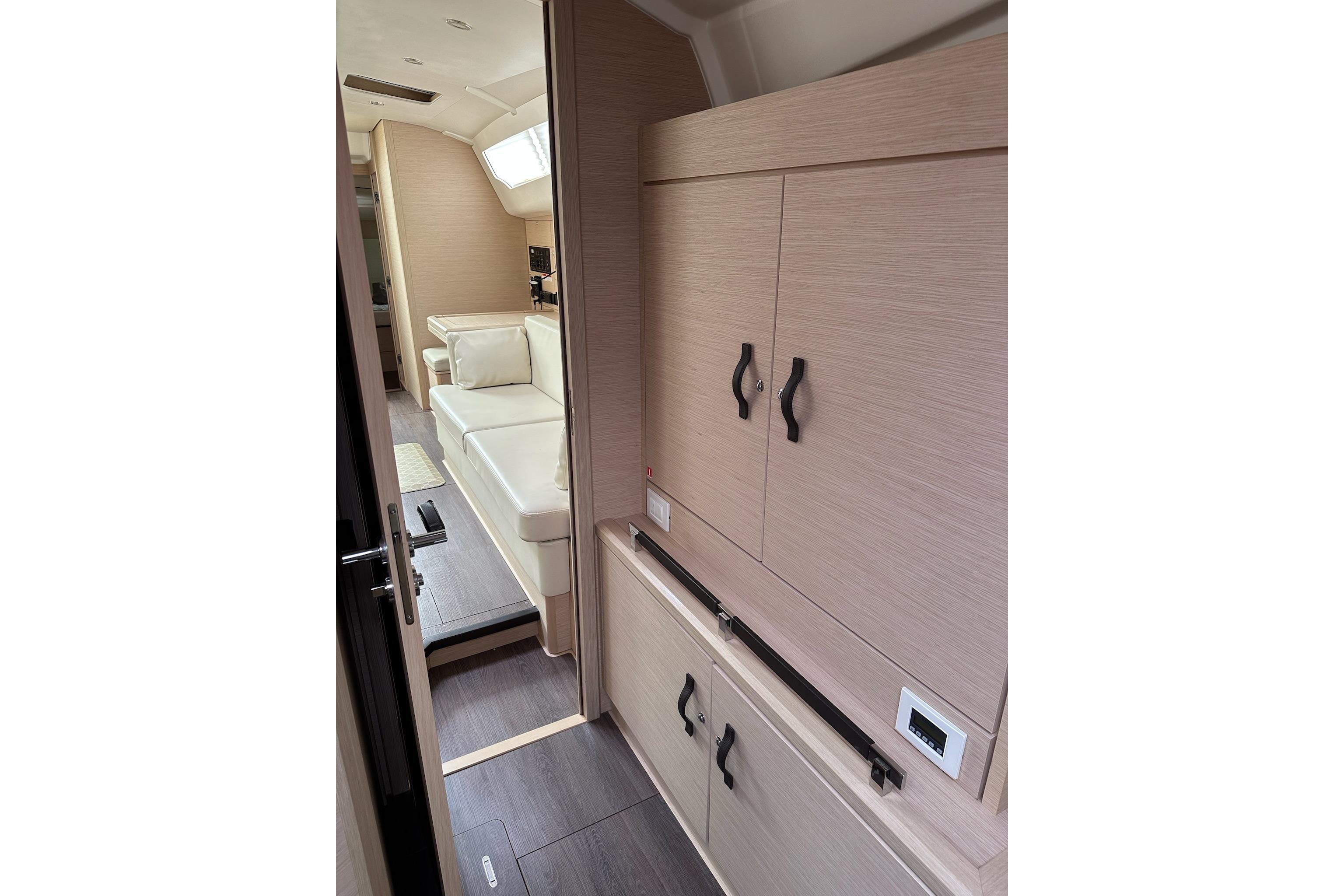 Interior of 2018 Jeanneau 51 yacht, featuring modern cabinetry and comfortable seating.