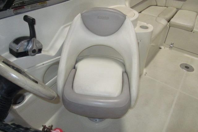 2004 Stingray 240 LR boat interior with steering wheel and cushioned seat.