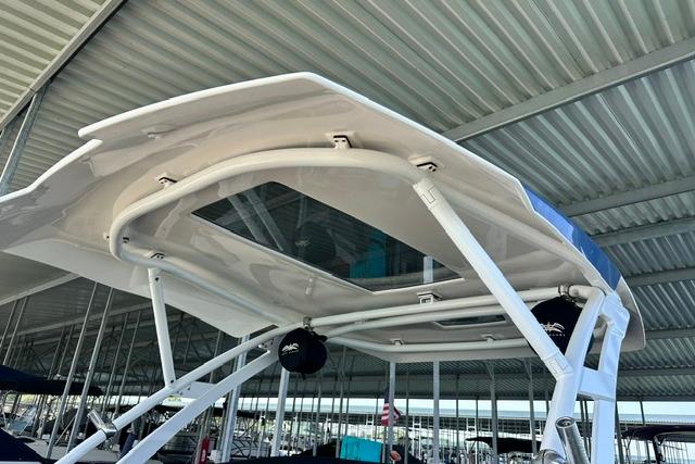 2021 Yamaha Boats 275SD with sleek canopy design in a covered marina.