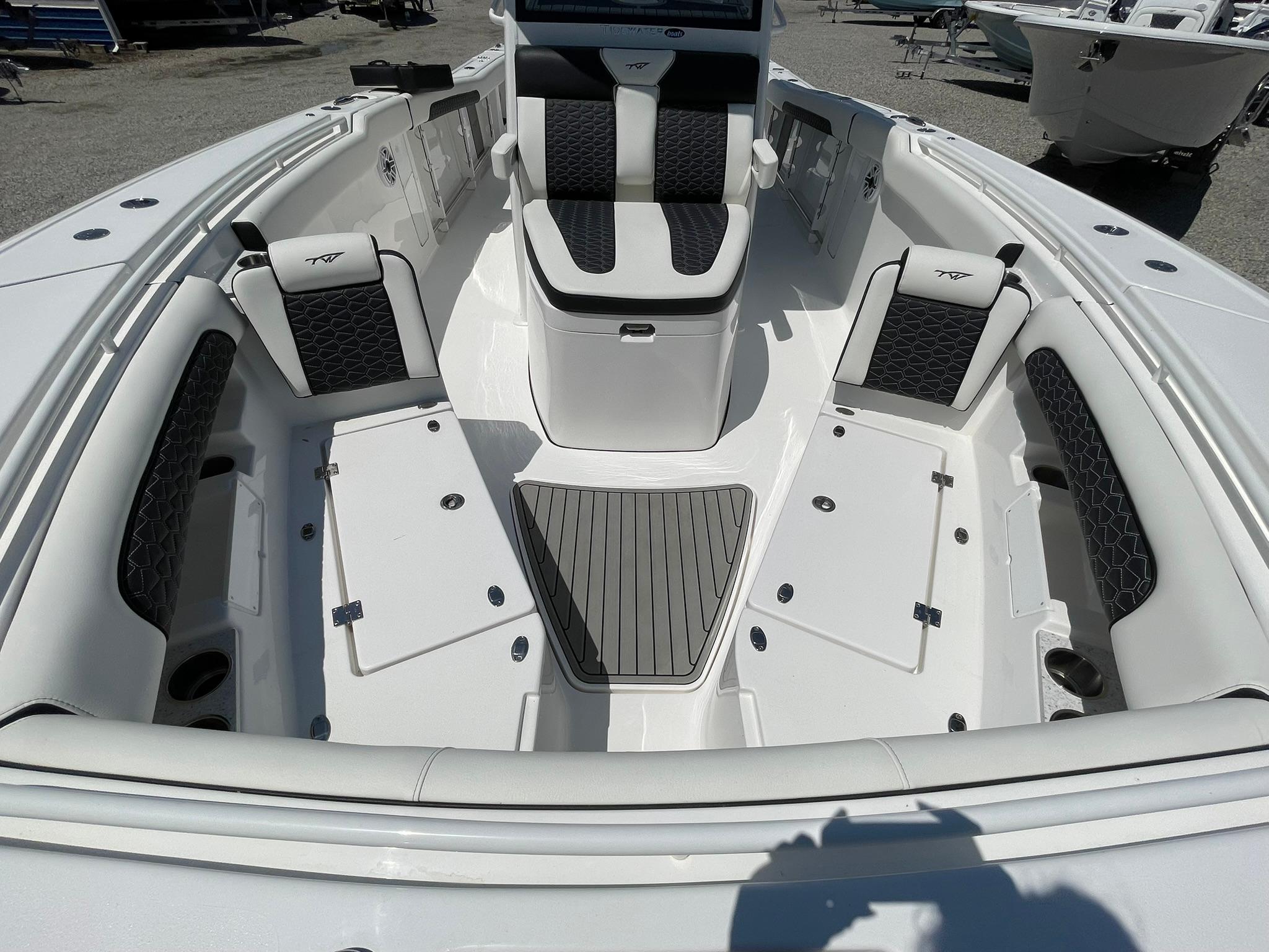 2026 Tidewater 302 CC Adventure boat interior with cushioned seating and storage compartments.